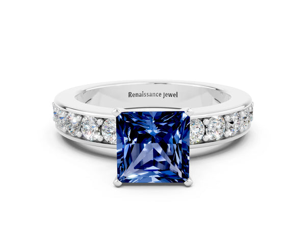 White gold Princess Cut Blue Sapphire Engagement Ring with Channel Set Round Band and Prong Setting