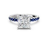 White gold Princess Cut Diamond Pave Band Solitaire Ring with Round with Blue Sapphire side stone and Prong Setting