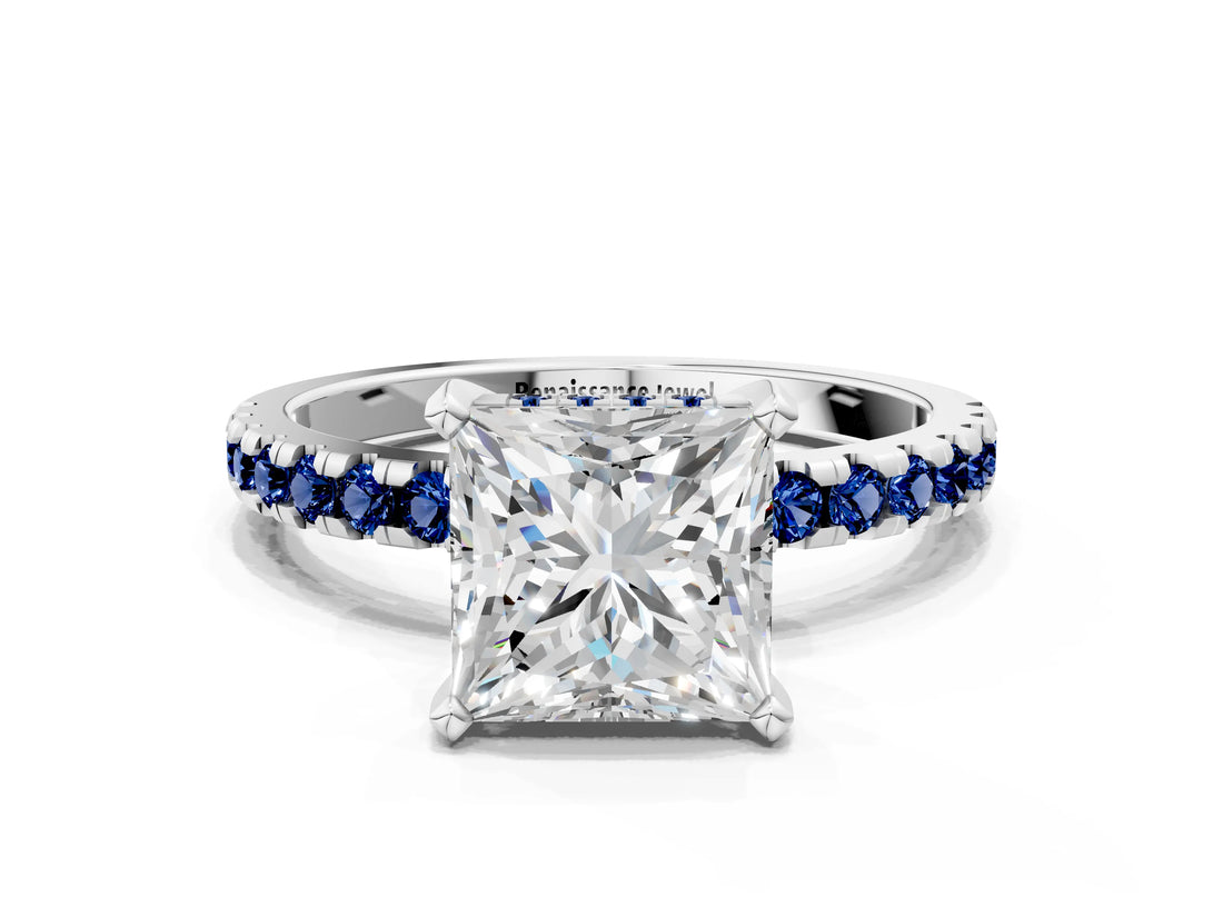 White gold Princess Cut Diamond Solitaire Ring with Round with Blue Sapphire side stone Pavé Band and Four-Prong Setting