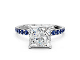White gold Princess Cut Diamond Solitaire Ring with Round with Blue Sapphire side stone Pavé Band and Prong Setting