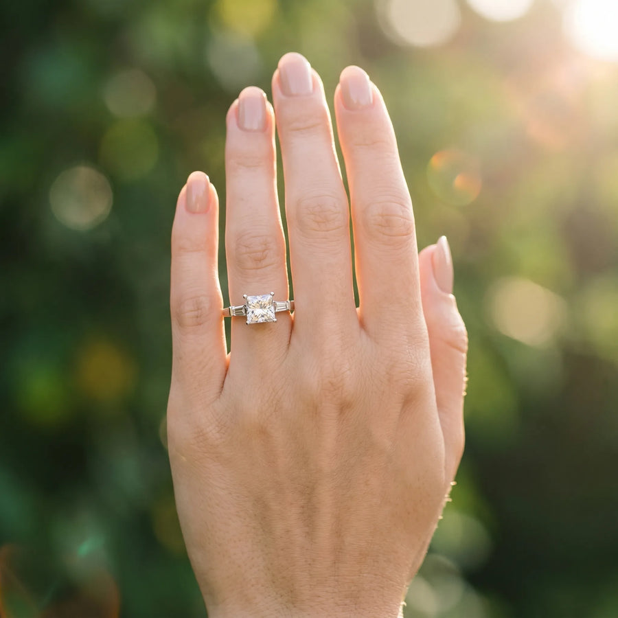 White gold Princess Cut Diamond Solitaire Ring with Tapered Baguette Accents and Four-Prong Setting