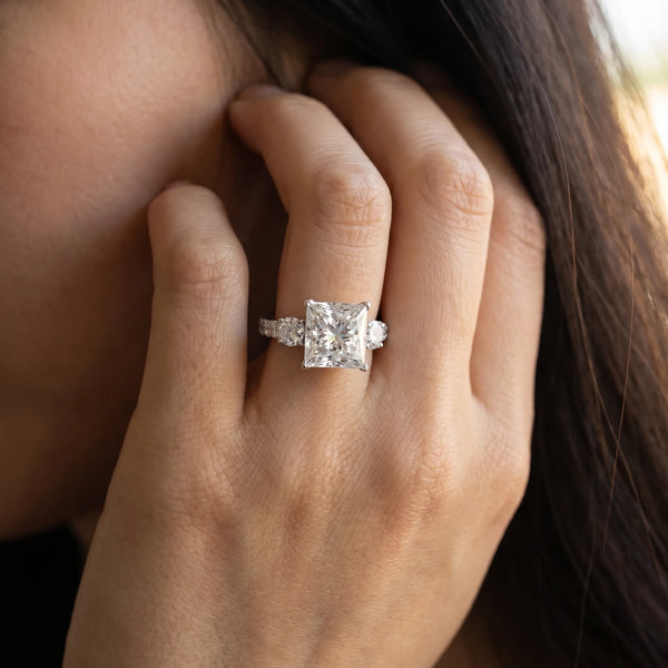 White gold Princess Cut Diamond Three-Stone Ring with Round Side Stones and Pavé Band