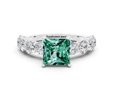 White gold Princess Cut Green Sapphire Prong Setting with Side Stones on a Pave Band