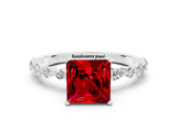 White gold Princess Cut Ruby Solitaire with Side Stones on a Pavé Band and Four-Prong Setting