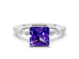White gold Princess Cut Tanzanite Solitaire with Side Stones on a Pavé Band and Four-Prong Setting