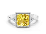 White gold Princess Cut Yellow Sapphire Halo Ring with Tapered Band and Four-Prong Setting