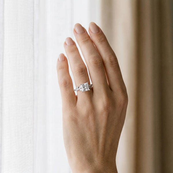 White gold Princess Solitaire Leaf-Inspired Diamond Ring with Pavé Band and Four-Prong Setting
