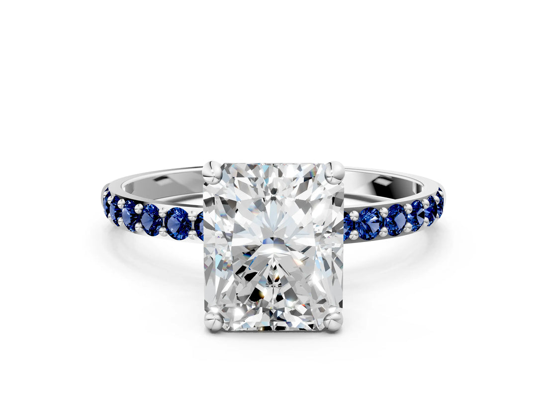 White gold Radiant Cut Diamond Solitaire Ring with Round with Blue Sapphire side stone Pavé Band and Prong Setting