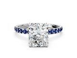 White gold Radiant Cut Diamond Solitaire Ring with Round with Blue Sapphire side stone Pavé Band and Prong Setting
