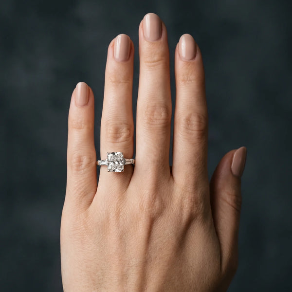 White gold Radiant Cut Diamond Solitaire Ring with Tapered Baguette Accents and Four-Prong Setting
