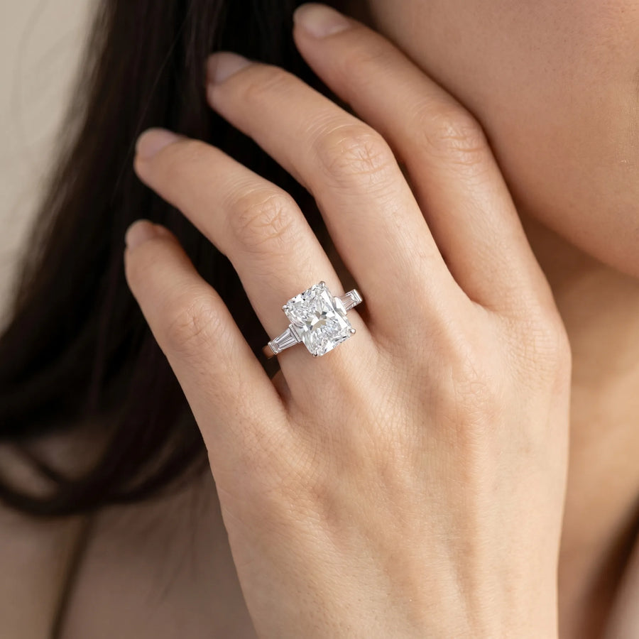 White gold Radiant Cut Diamond Solitaire Ring with Tapered Baguette Accents and Four-Prong Setting