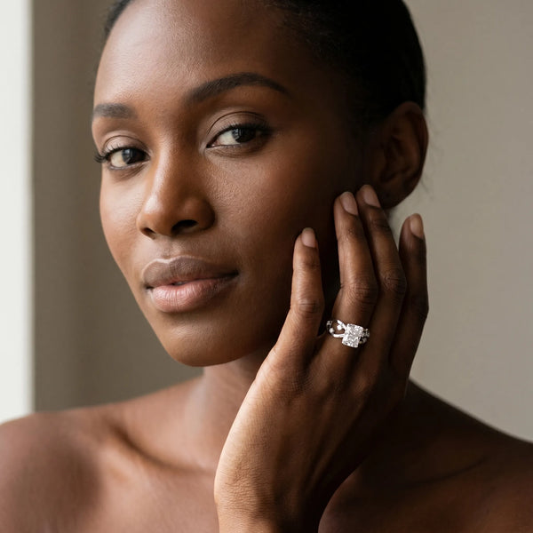 White gold Radiant Cut Solitaire Diamond with Side Stones on Criss-Cross Band and Four-Prong Setting