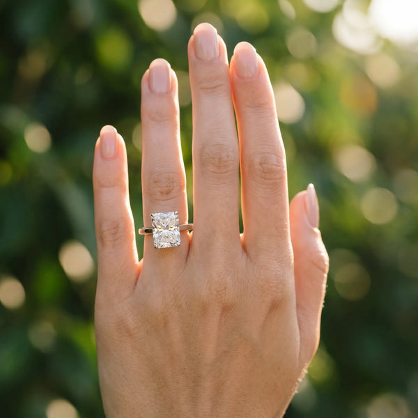 White gold Radiant Cut Solitaire Engagement Ring with Four-Prong Setting on a Classic Band