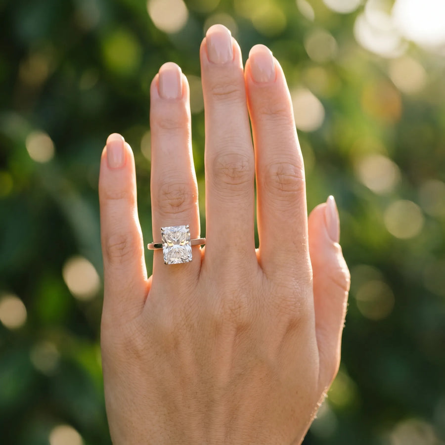 White gold Radiant Cut Solitaire Engagement Ring with Four-Prong Setting on a Classic Band