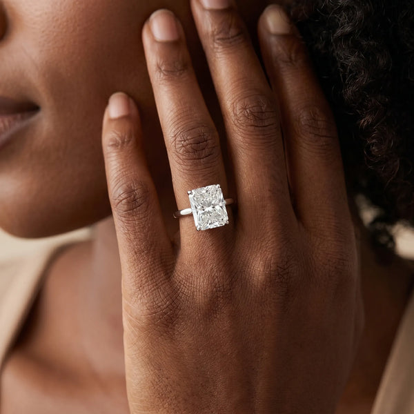 White gold Radiant Cut Solitaire Engagement Ring with Four-Prong Setting on a Classic Band