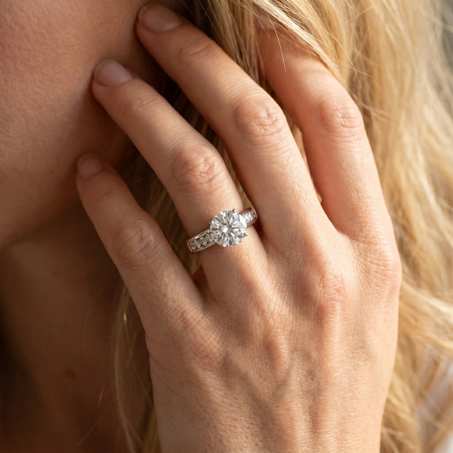 White gold Round Brilliant Channel-Set Solitaire Ring with Four-Prong Setting