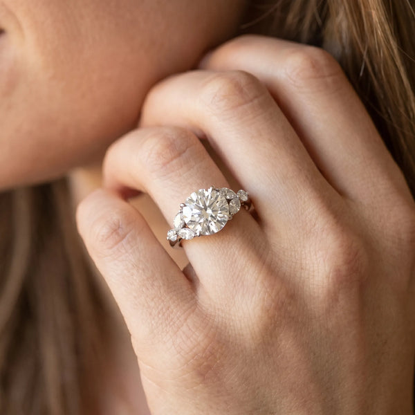 White gold Round Brilliant Cluster Diamond Ring with Marquise and Round Cut Stones on a Classic Band with Four-Prong Setting