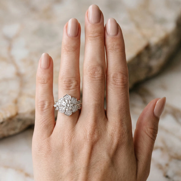 White gold Round Brilliant Diamond Floral Halo Ring with Pavé Band and Four-Prong Setting