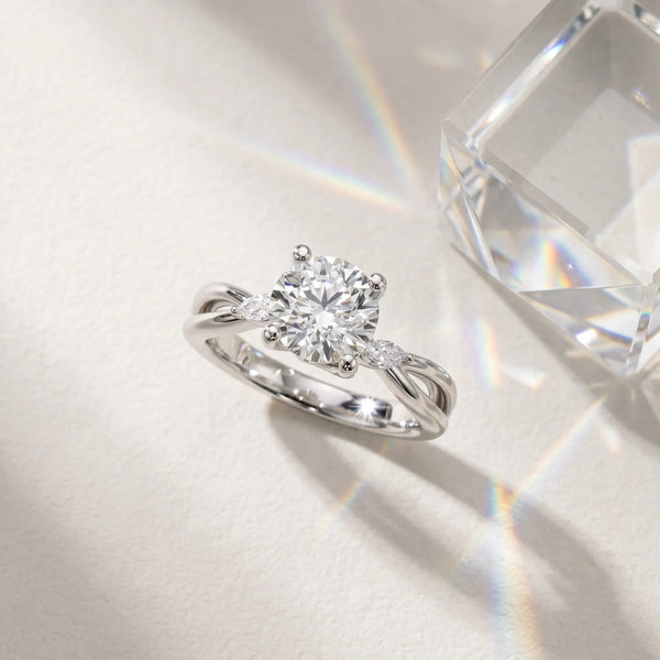 White gold Round Brilliant Diamond Solitaire with Marquise Side Stones on a Twisted Band and Four-Prong Setting