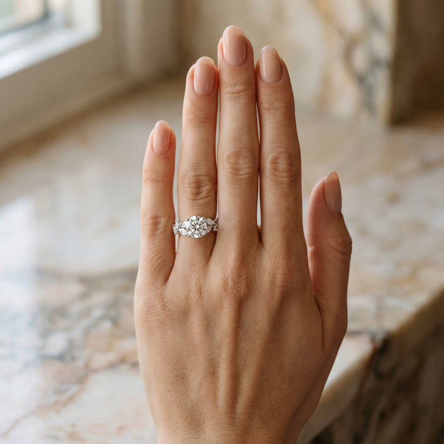 White gold Round Brilliant Diamond Solitaire with Marquise and Pear Accent Stones on a Split Shank Band with Four-Prong Setting