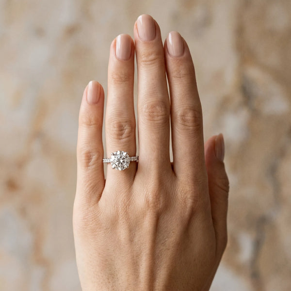 White gold Round Brilliant Diamond Solitaire with Pavé Band and Four-Prong Setting