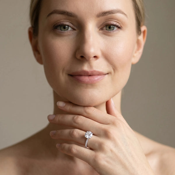 White gold Round Brilliant Diamond Solitaire with Pavé Band and Four-Prong Setting