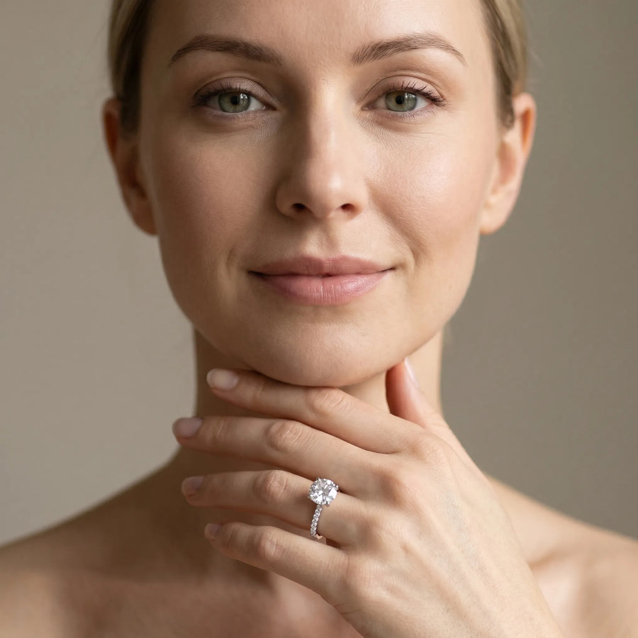 White gold Round Brilliant Diamond Solitaire with Pavé Band and Four-Prong Setting