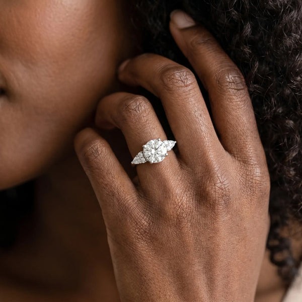 White gold Round Brilliant Diamond Solitaire with Side Stones on a Tapered Band and Four-Prong Setting