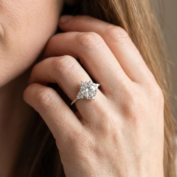 Platinum Cushion Cut Brilliant Diamond with Cluster Setting on a Beaded Band and Four-Prong Setting