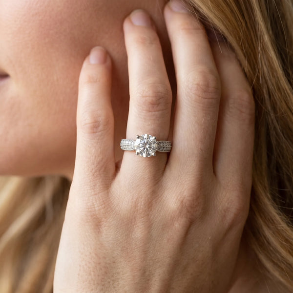 White gold Round Brilliant Solitaire Engagement Ring with Pave Band and Four-Prong Setting
