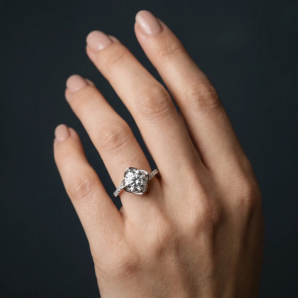White gold Round Brilliant Solitaire with Pavé Band and Four-Prong Cushion Setting