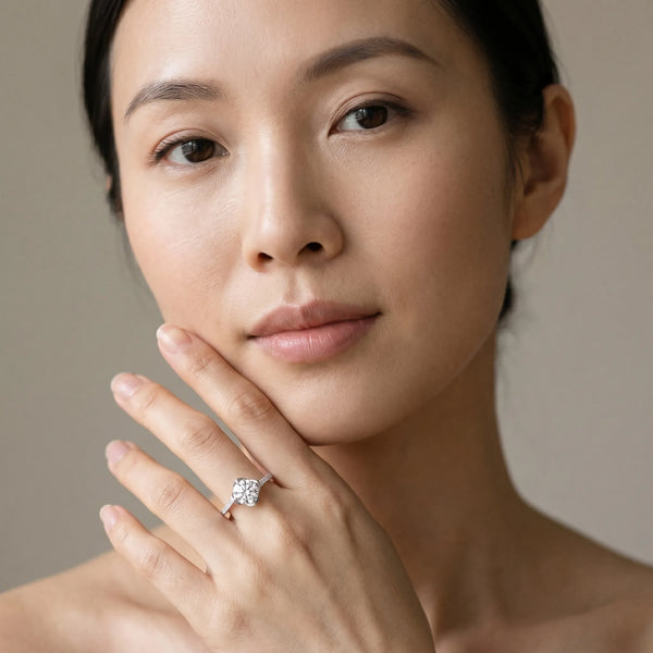 White gold Round Brilliant Solitaire with Pavé Band and Four-Prong Cushion Setting
