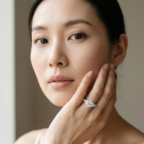 White gold Round Brilliant Solitaire with Side Stones on a Pave Band and Four-Prong Setting