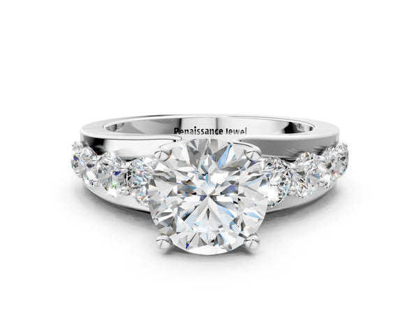 White gold Round Brilliant Solitaire with Side Stones on a Pave Band and Four-Prong Setting