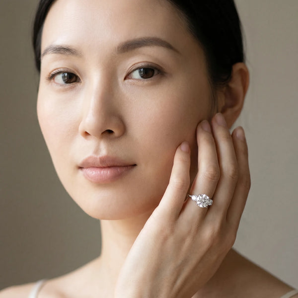 White gold Round Brilliant Three-Stone Diamond Ring with Pavé Band and Four-Prong Setting