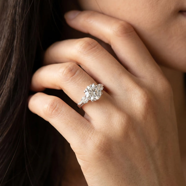 White gold Round Brilliant Three-Stone Diamond Ring with Pavé Band and Four-Prong Setting