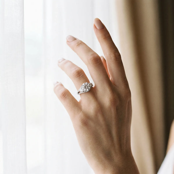 White gold Round Brilliant Three-Stone Diamond Ring with Pavé Band and Prong Setting
