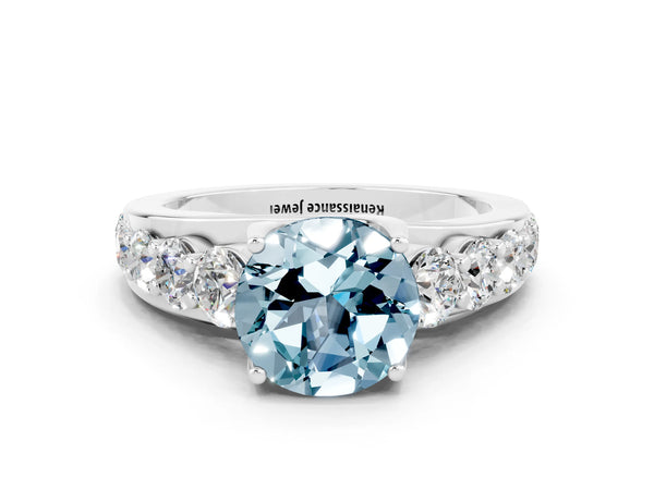Silver Round Cut Aquamarine Engagement Ring with Pavé Band and Four-Prong Setting