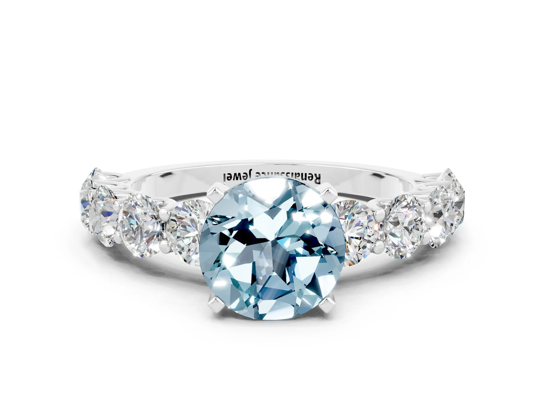 White gold Round Cut Aquamarine Prong Setting with Side Stones on a Pave Band
