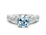 White gold Round Cut Aquamarine Prong Setting with Side Stones on a Pave Band