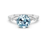 White gold Round Cut Aquamarine Solitaire with Side Stones on a Pavé Band and Four-Prong Setting