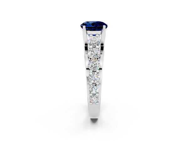 Platinum Round Cut Blue Sapphire Engagement Ring with Pavé Band and Four-Prong Setting