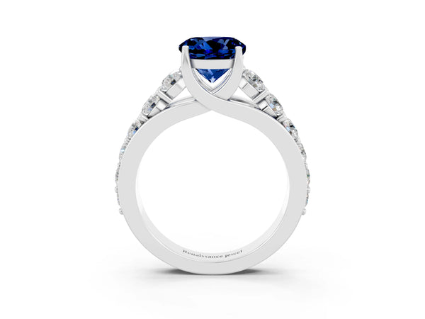 Platinum Round Cut Blue Sapphire Engagement Ring with Pavé Band and Four-Prong Setting