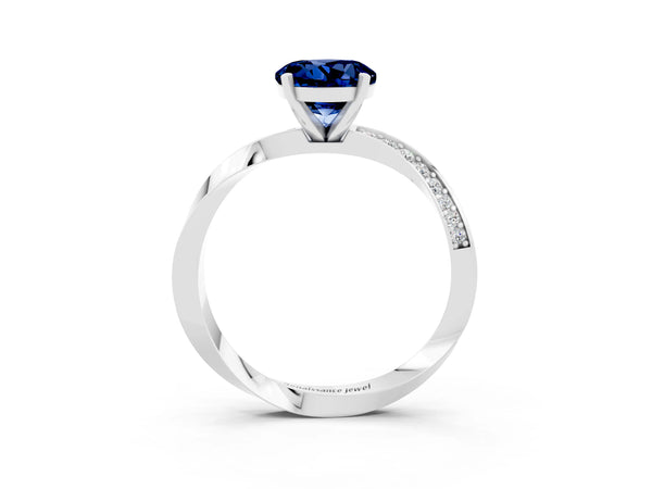 Platinum Round Cut Blue Sapphire Engagement Ring with Side Stone Accents and Four-Prong Setting
