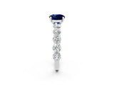 White gold Round Cut Blue Sapphire Prong Setting with Side Stones on a Pave Band_2