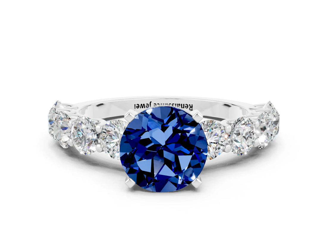White gold Round Cut Blue Sapphire Prong Setting with Side Stones on a Pave Band