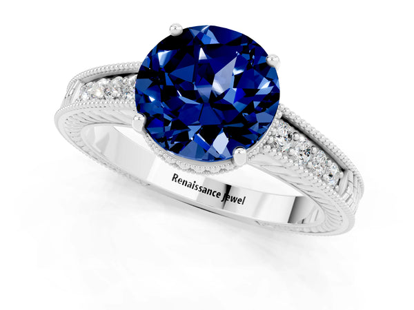Platinum Round Cut Blue Sapphire Ring with Milgrain Pavé Band and Four-Prong Setting