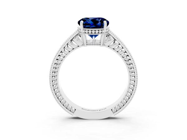 Platinum Round Cut Blue Sapphire Ring with Milgrain Pavé Band and Four-Prong Setting