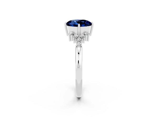 Platinum Round Cut Blue Sapphire Ring with Side Stones and Four-Prong Setting