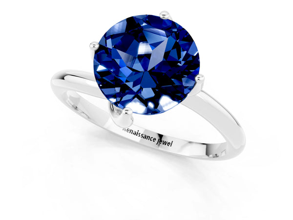 Silver Round Cut Blue Sapphire Solitaire Engagement Ring with Four-Prong Setting and Classic Band